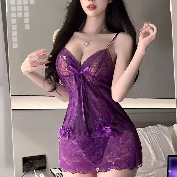 Woman wearing purple sheer lace lingerie sleep dress with bow details, flirty and feminine bedroom outfit.