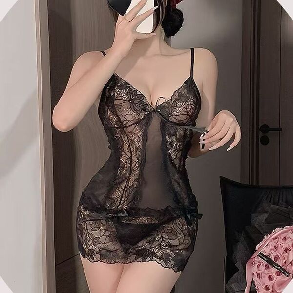 Woman wearing sheer black lace lingerie sleep dress, flirty and feminine bedroom outfit with floral details.