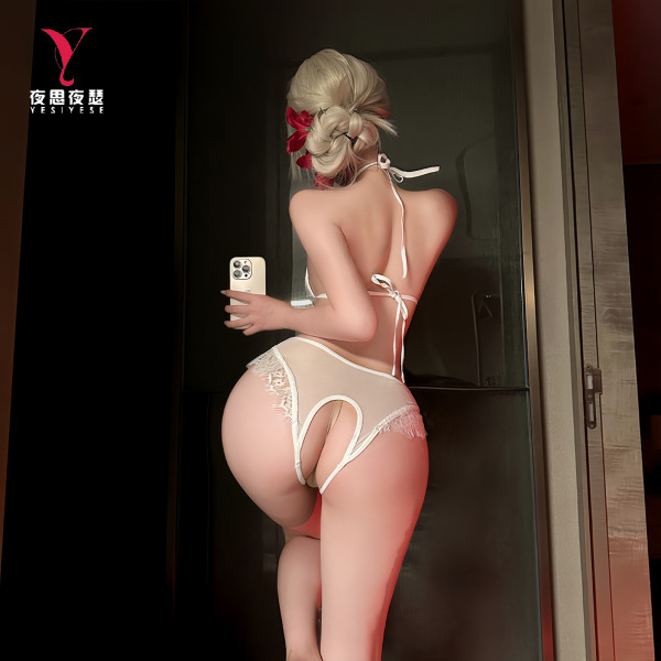 Woman in purple sensual lingerie set with open-crotch design, posing by mirror. sexy nightwear uniform style.