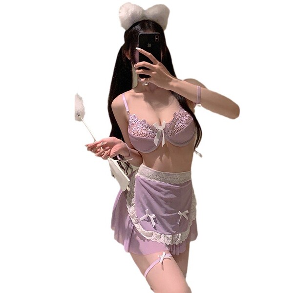 A woman poses in a purple lingerie set featuring sheer lace details, a maid costume skirt, and cheeky backless design element...