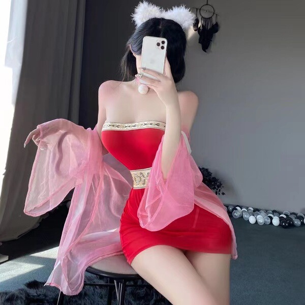 A woman poses with a smartphone, wearing a red qiaoduo hanfu-inspired bodysuit paired with a sheer pink skirt. the outfit fea...