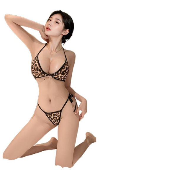 Woman wearing qiaozi leopard print lingerie set with strapless bra and thong, kneeling pose.