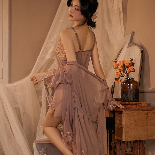 Woman wearing qing lian yi plus size lingerie set with seductive slip dress and flowing robe, posing beside vintage vanity wi...
