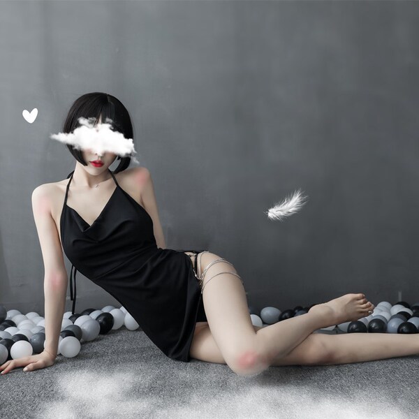 A woman poses in a black qingran sexy lace chemise set, featuring a backless design with a slit, perfect for sleepwear or lou...