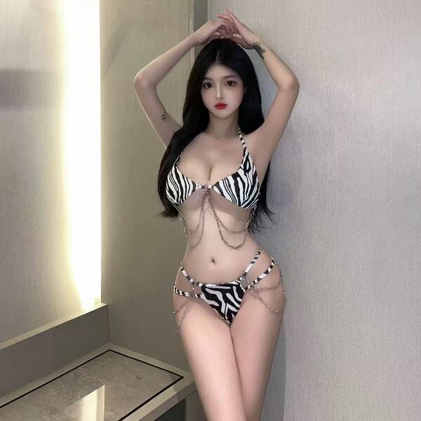 Woman modeling qingran sexy leopard print lingerie set with deep v halter bra and matching thong, featuring chain details.