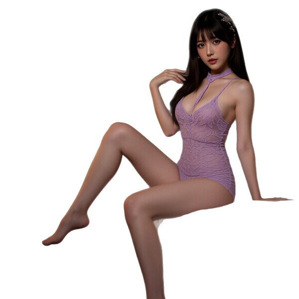 A woman poses elegantly wearing a purple halter bodysuit, showcasing its intricate design and feminine appeal as part of the ...