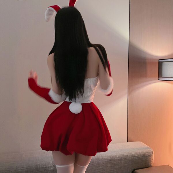 Woman in red and white christmas bunny costume with fluffy trim, back view showing short skirt, gloves, and ears.