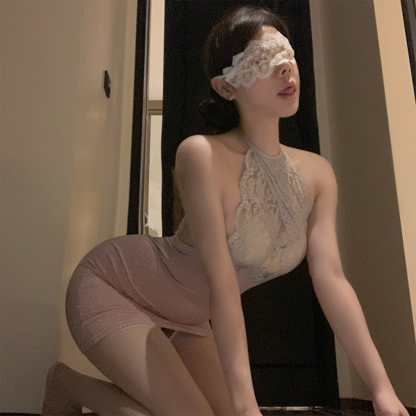 Woman in qqny maid costume lingerie set, featuring a lace halter top and pink skirt, posing seductively with a blindfold.