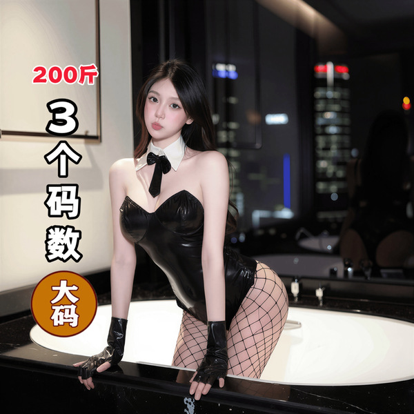 Woman in black qqny pure allure lingerie set with fishnet stockings, posing elegantly by a modern bathtub.