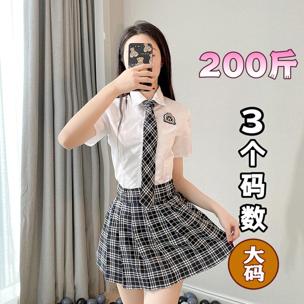A woman wearing a white blouse with a black plaid skirt, taking a mirror selfie. the outfit features a tie and has text indic...
