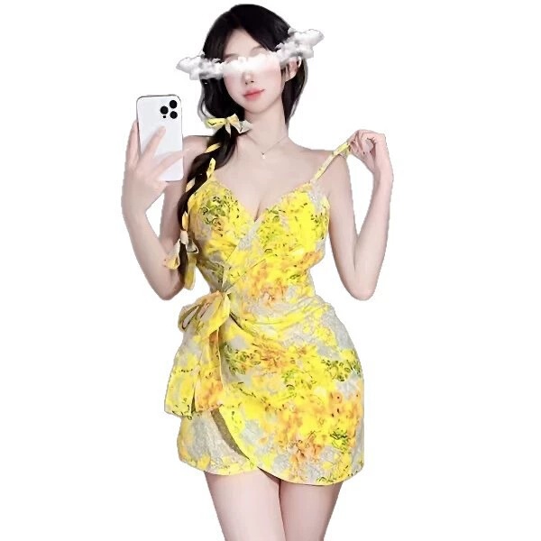 Woman wearing qqny pure allure sleepwear set, a yellow floral lingerie dress with bow straps and wrap waist.