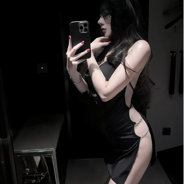 Woman in qqny pure & sexy knotted neckline sleep dress, body-con nightwear for date nights and lounge wear, posing with phone...