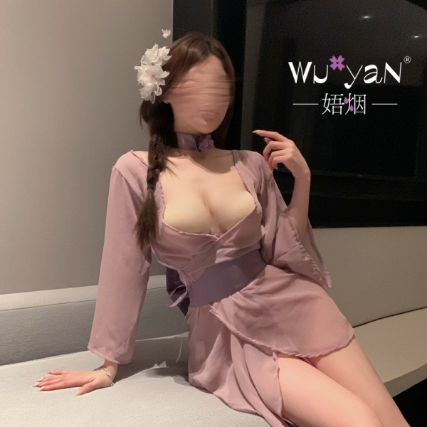 Woman in pink qqny lingerie set with floral hair accessory, showcasing elegant and playful nightwear design.