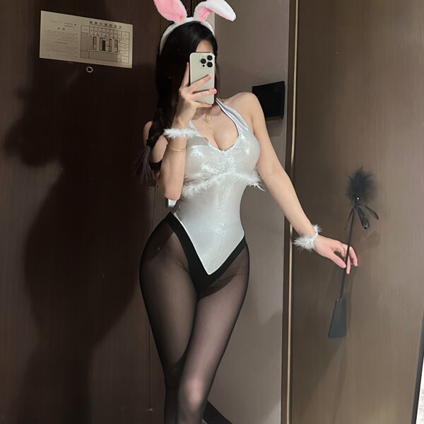 Sexy rabbit-themed costume set featuring a sparkling bodysuit, fluffy headband, and feathered accessories perfect for parties...