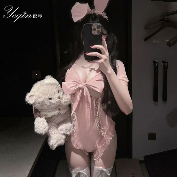 Woman in pink rabbit girl costume set with chest cutout, holding teddy bear — sexy lingerie bodysuit for adult role play.