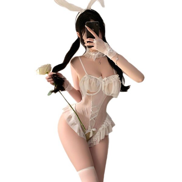 Woman wearing white rabbit girl costume with sheer lace bodysuit, bunny ears, gloves, and holding a rose.
