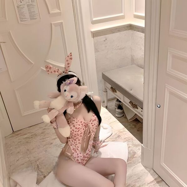 Woman in rabbit girl lingerie set with bunny ears and plush toy, perfect for role play and passionate nights.