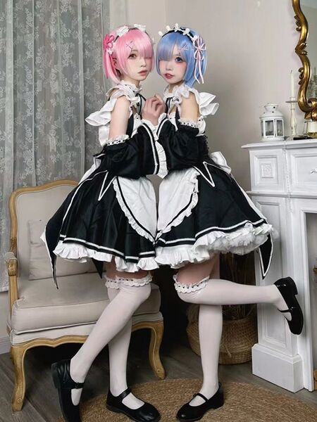 Two cosplayers dressed as ram and rem from re:zero, wearing maid outfits in lolita style. black and white dresses with ruffle...