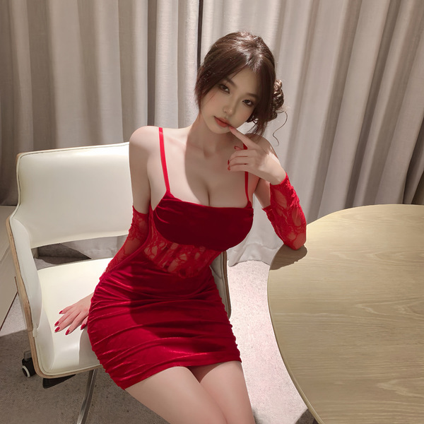 A woman poses elegantly in a red velvet dress featuring sheer lace sleeves, perfect for festive occasions or intimate wear.