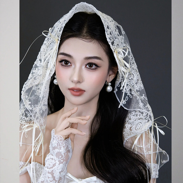 Elegant white lace veil with delicate bows, perfect for adding a touch of french chic to any brides look for photoshoots and ...