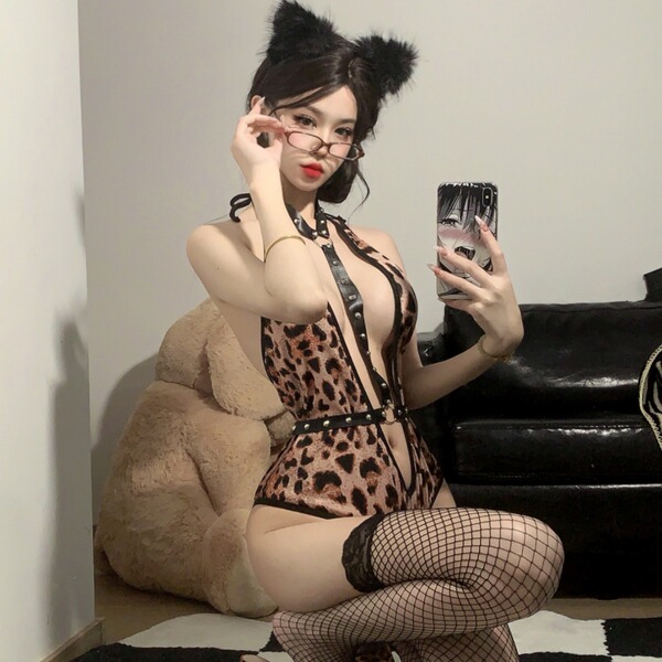 Sexy leopard print bodysuit with crotch cutout, studs, and cat ears for bold confidence. perfect wild temptress costume.
