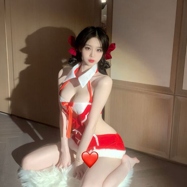 A woman poses in a festive red and white christmas-themed nightgown, featuring playful bows and a cute design, perfect for ho...