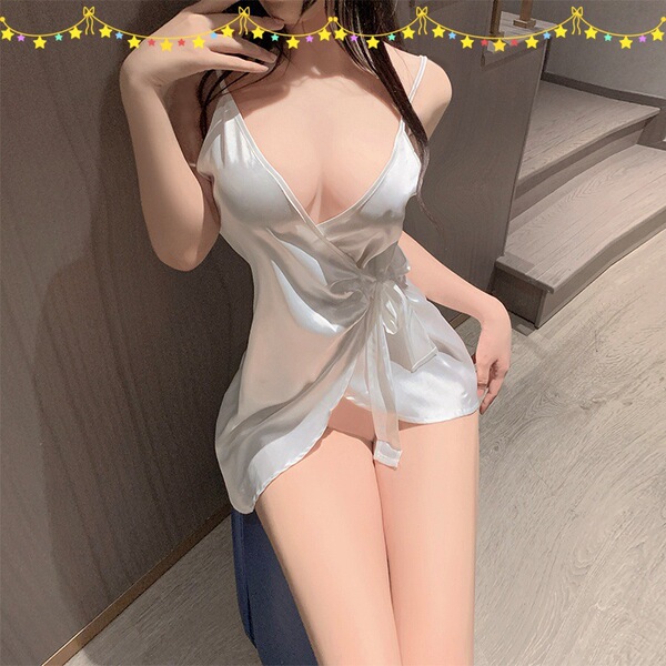 Woman wearing a white satin sleep dress with ties, showcasing its alluring design perfect for summer lounging or intimate nig...