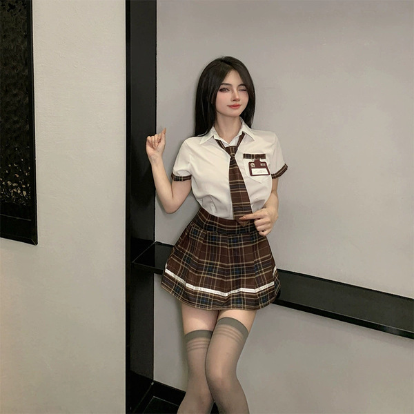 A stylish schoolgirl costume set featuring a white blouse, plaid skirt, tie, and stockings, perfect for a playful and allurin...