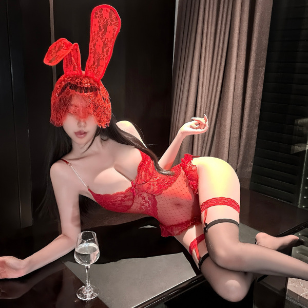 Woman in red lace bodysuit with bunny ears, sheer mesh, pearl chain detail, and thigh-high stockings.