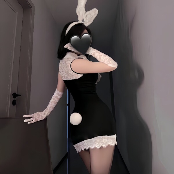 Woman in black secretary bunny girl lingerie set with lace gloves, ears, and tail - sexy ol uniform role play outfit.