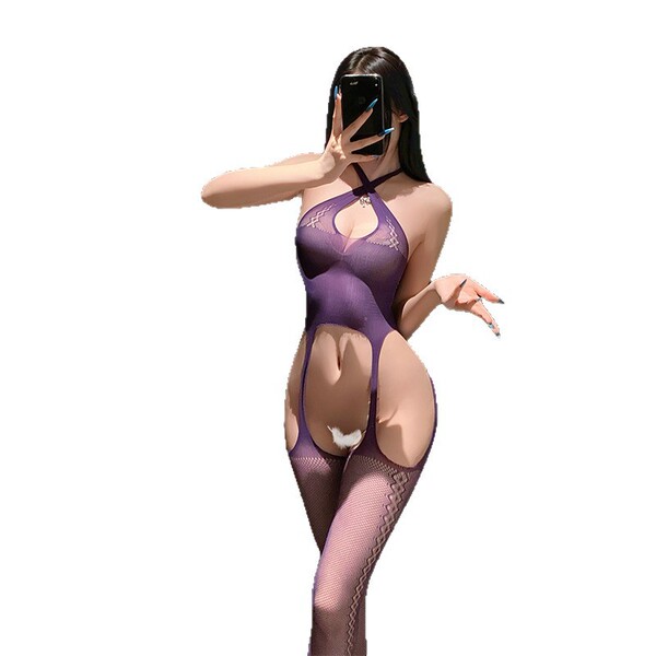 Woman wearing a purple sheer bodystocking with open crotch and suspender stockings, taking a mirror selfie.