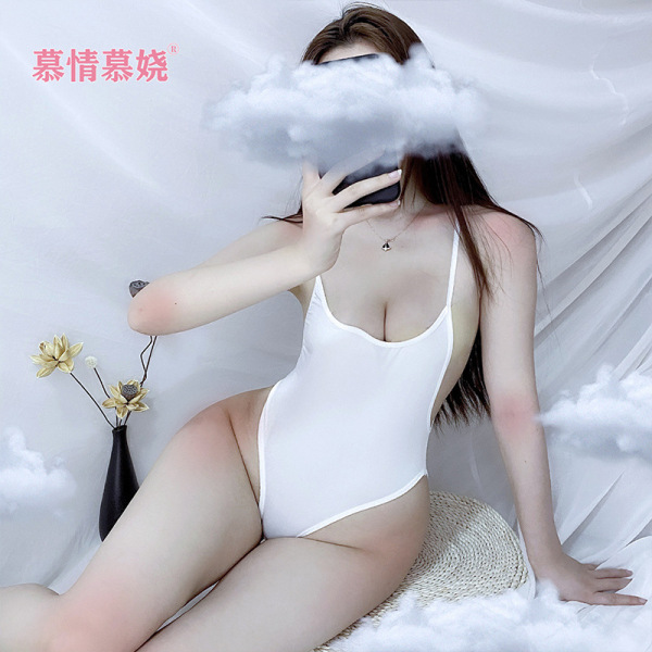 Woman wearing white backless low-cut bodysuit swimwear, sitting on cloud-like surface with floral decor.