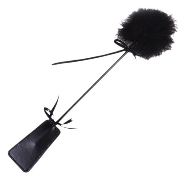 Black feather tickler with leather handle and ribbon ties for playful sensory play.