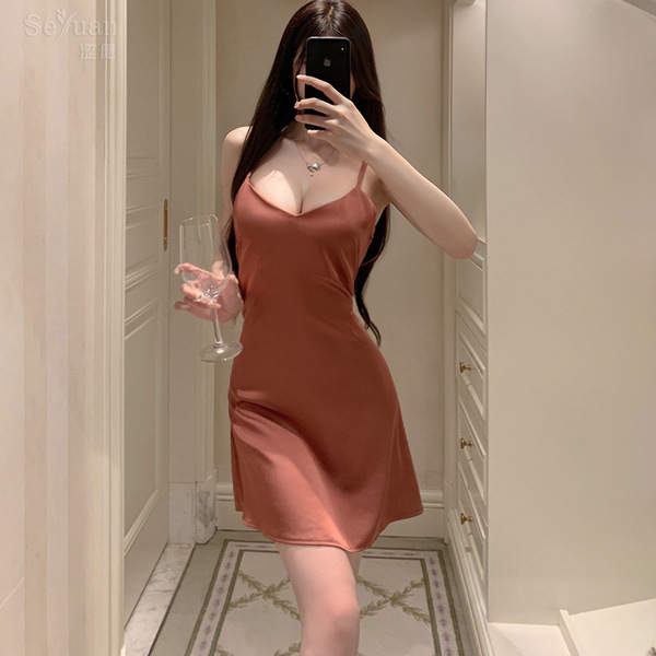 A woman takes a mirror selfie wearing a seductive lace slip dress paired with a matching bralette, holding a glass of wine. t...
