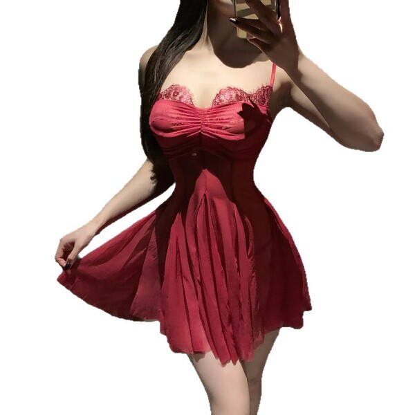 Woman wearing a red lace mesh slip dress with pleated skirt, showcasing a seductive and provocative lingerie outfit.