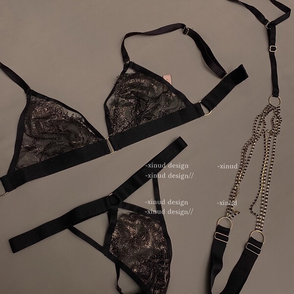 Black lace tie-back bikini set with intricate floral patterns, featuring a bralette and matching thong, complemented by elega...