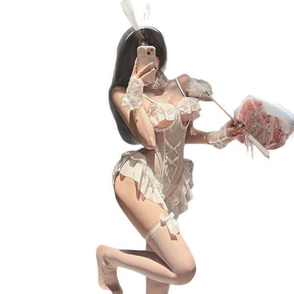 Woman in white bunny lingerie set with open-crotch design, holding bouquet and phone for selfie.