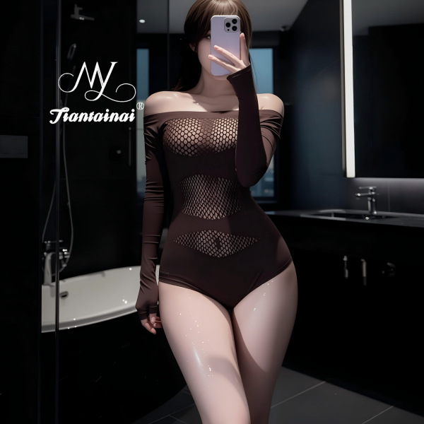 Woman in bathroom wearing sheer brown lace mesh lingerie set with long sleeves and fishnet panels.