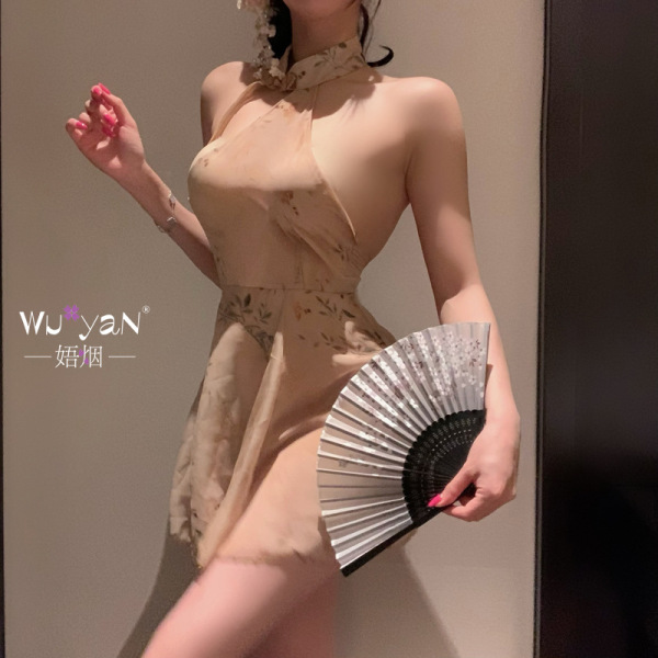 Woman in a beige floral qipao lingerie set holding a fan, exuding elegance and allure.