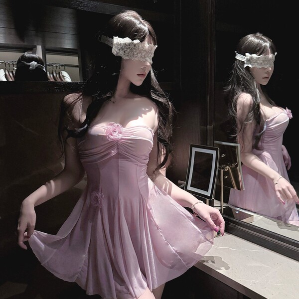 Woman in pink sheer lace sleep dress with underwire, floral details, and blindfold—sexy wife-inspired nightwear.
