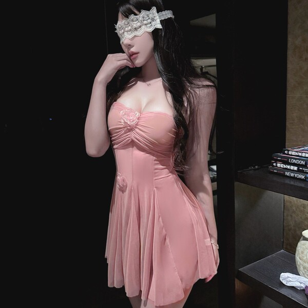 Woman wearing pink sheer lace sleep dress with underwire support, floral details, and matching eye mask.