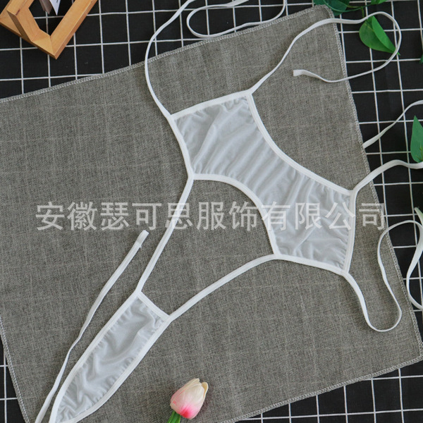 White sheer mesh sleepwear set with delicate ties, displayed on a textured gray fabric background.