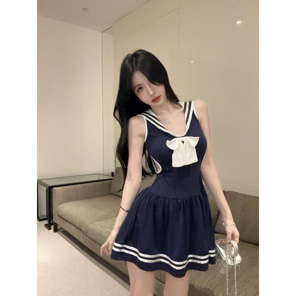 A stylish navy schoolgirl dress with white trim and bow detail, perfect for a cute and sexy look.