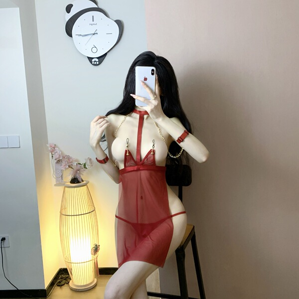 Woman modeling a red semi-sweet lace lingerie set with sheer mesh and gold chain details in a mirror selfie.