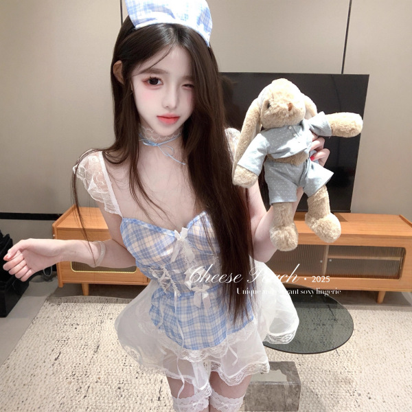 Model wearing sensual deep v lace sheer maid outfit with plaid mini skirt and strap top, holding a teddy bear.