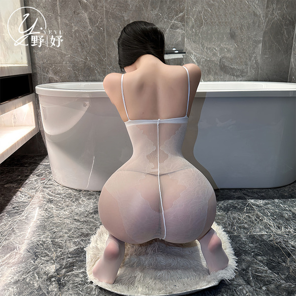 Woman kneeling in bathroom wearing sensual full-body mesh bodystocking with open-crotch design – sexy seamless sheer lingerie...