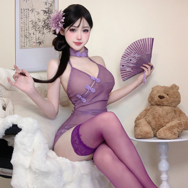 Woman wearing purple sheer lace qipao lingerie set with floral accents, holding fan, seated beside teddy bear.