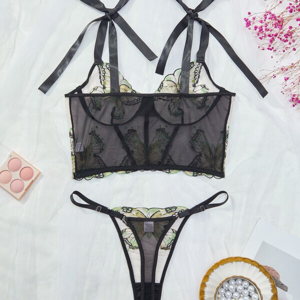 Sensual lace sheer lingerie set with embroidered details, featuring a transparent bra and matching thong for women.