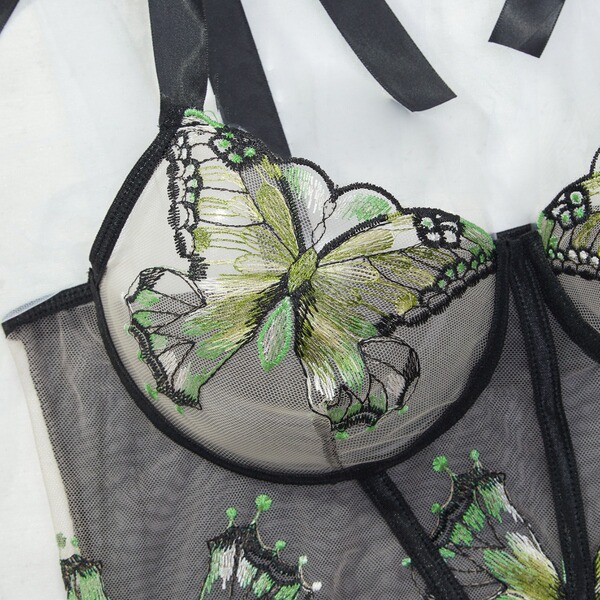 Sensual lace sheer lingerie set featuring intricate green butterfly embroidery on transparent fabric with black trim details.