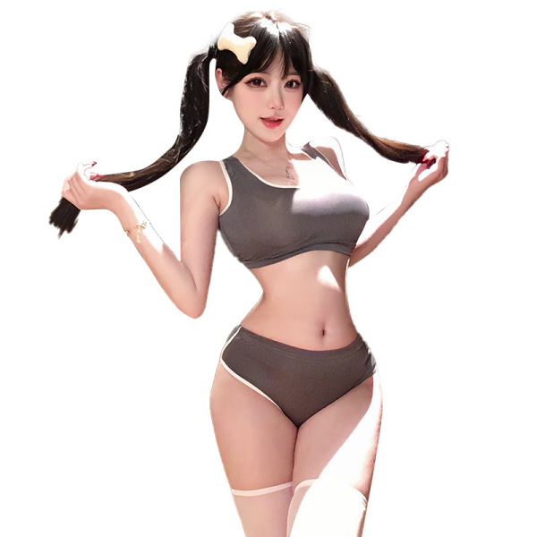 Woman modeling gray crop top and high-waisted shorts with lace trim, sporty chic set.